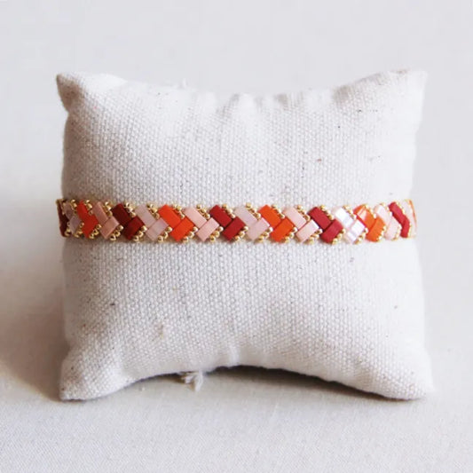 Gevlochten tilabead armband - zalm/oranje/bordeaux