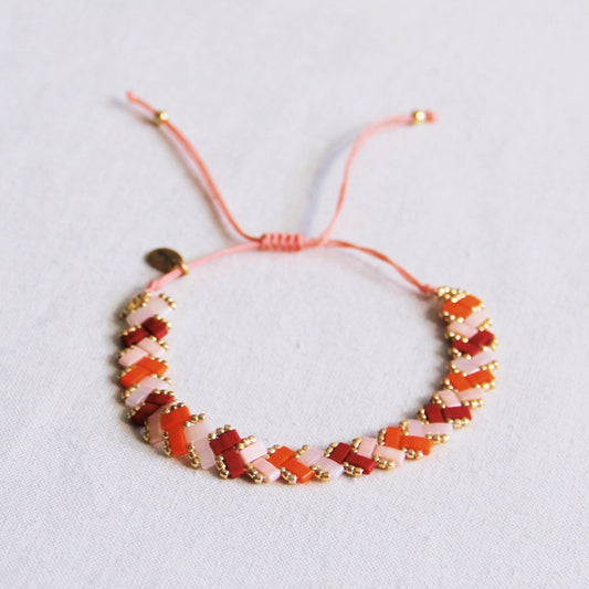 Gevlochten tilabead armband - zalm/oranje/bordeaux