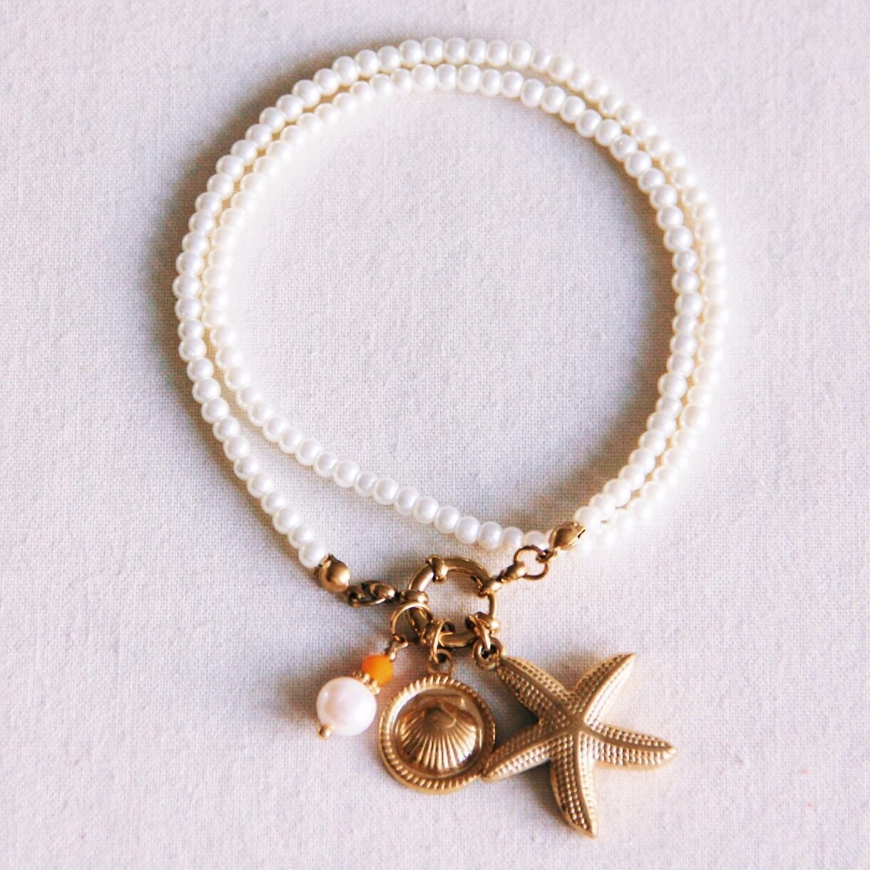 Parelketting met zeester, schelp en facet
